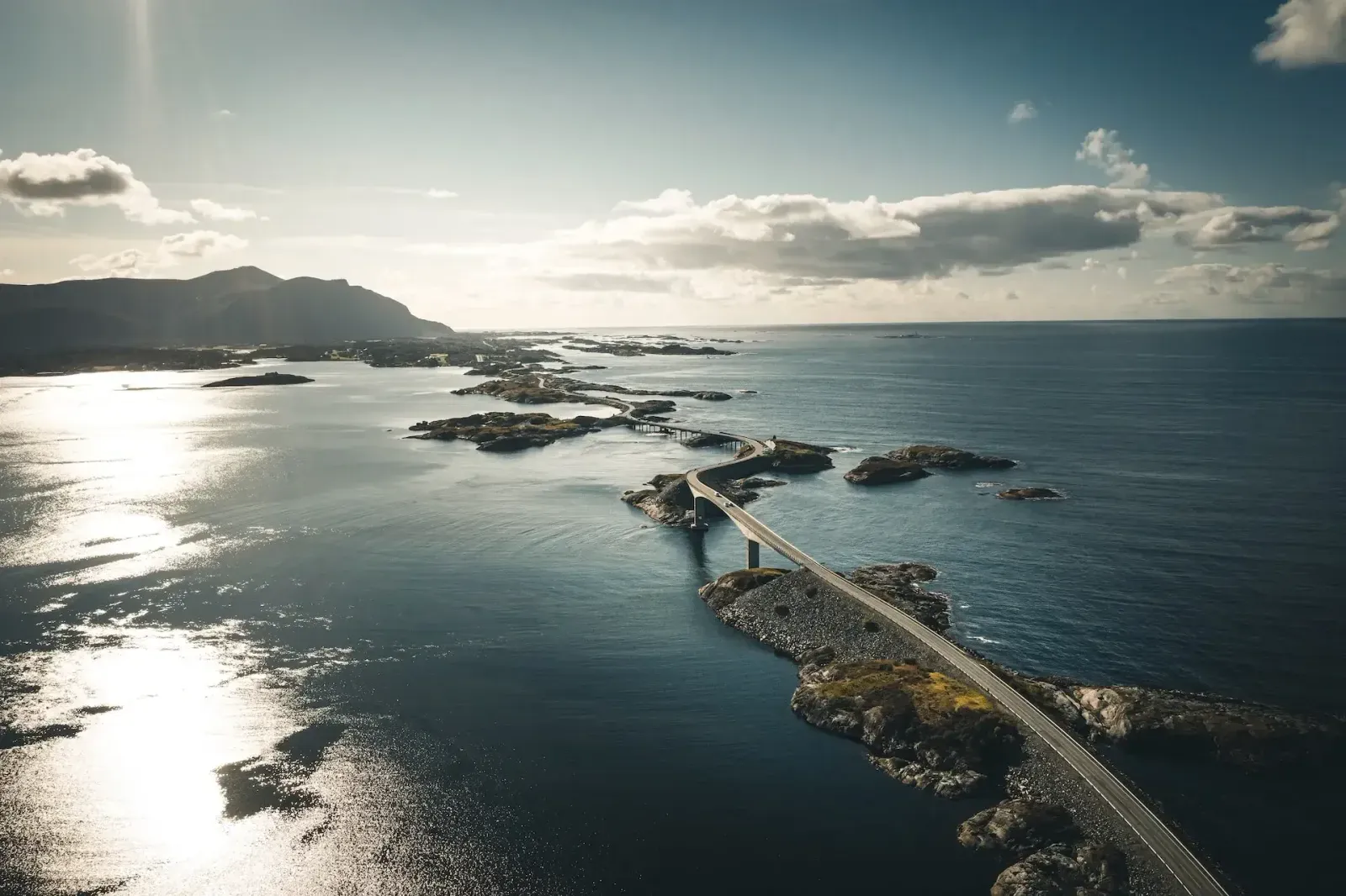 Aerial view of the Atlantic Road crossing a chain of small islands and bridges in the sea.