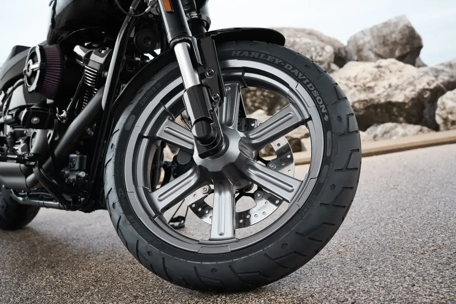 Close-up of a Harley-Davidson front tire and cast wheel with plenty of tread left.